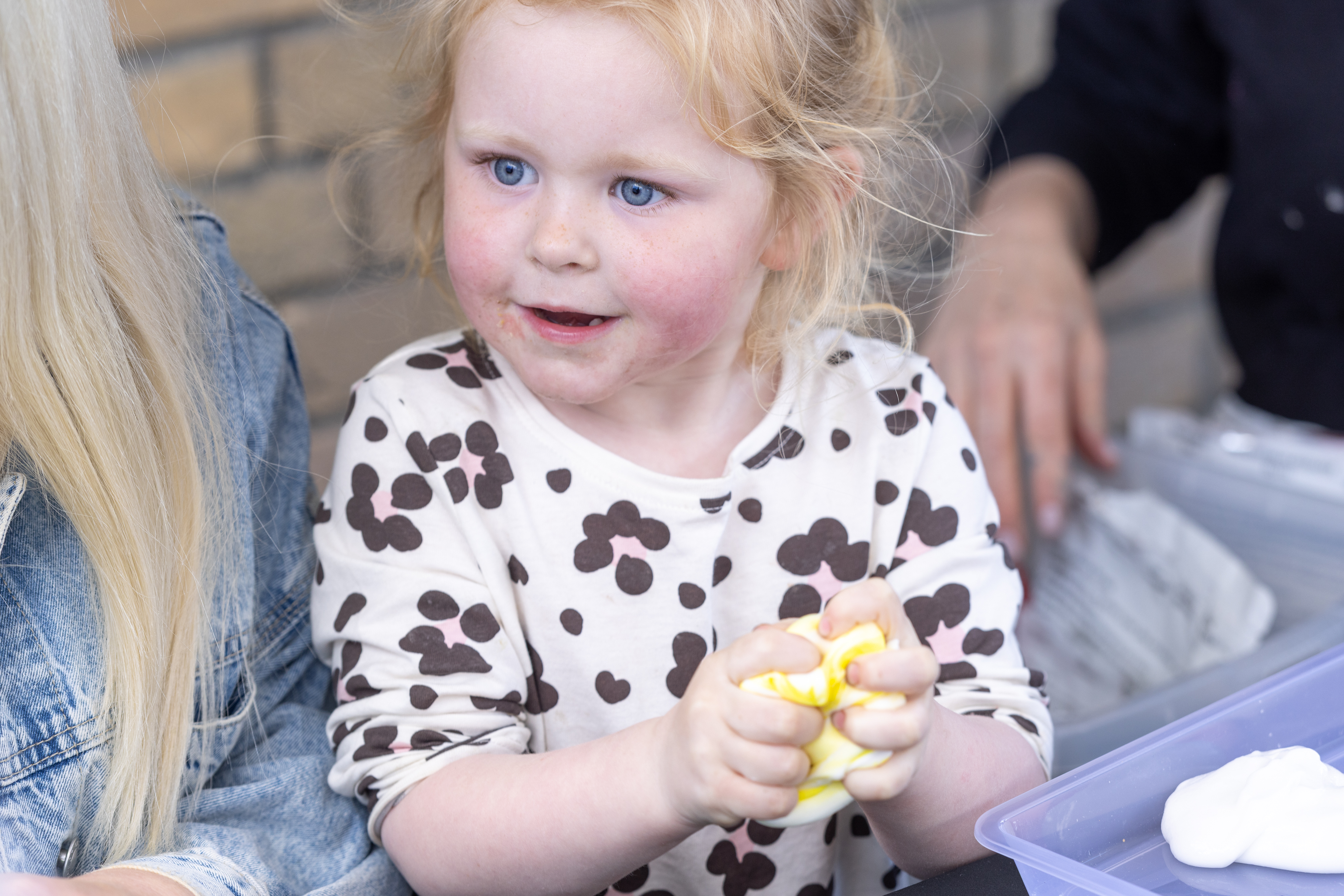 Child playing with slime. 